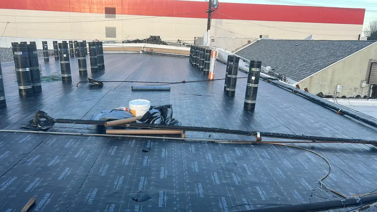 Low-slope roof work detail with rolled roofing material