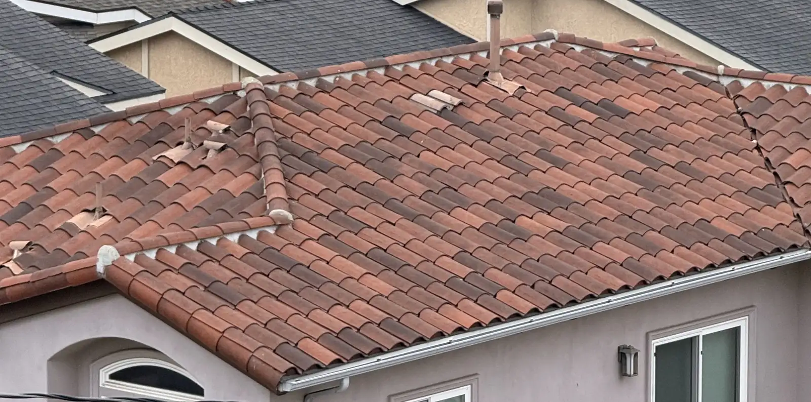 Clay tile roof planes with displaced tiles