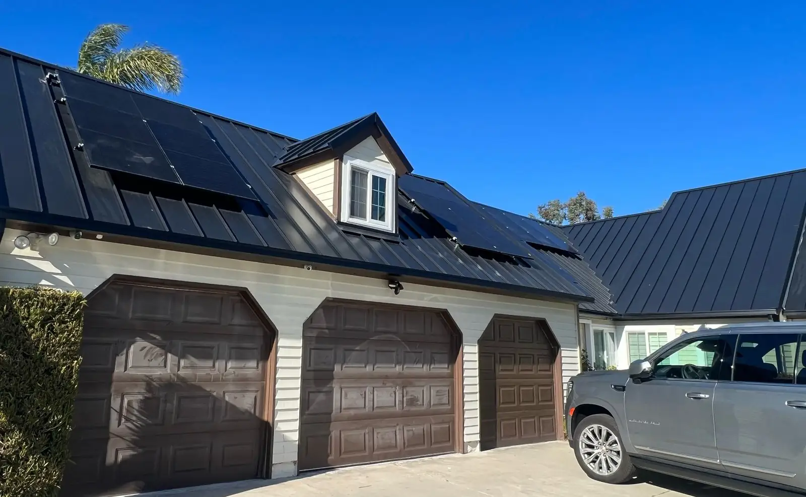 Black standing-seam metal roof with solar panels
