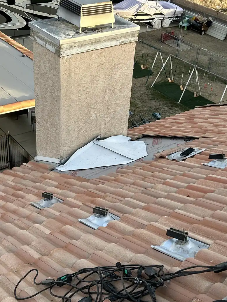 Terracotta tile roof with chimney and penetrations