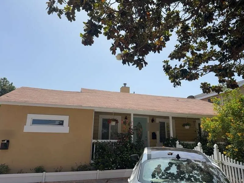 Pinkish asphalt shingle roof on front elevation